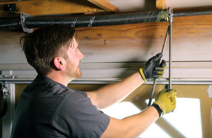 expert changing garage door springs