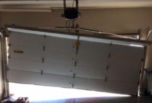 Garage door hanging crooked and off its track